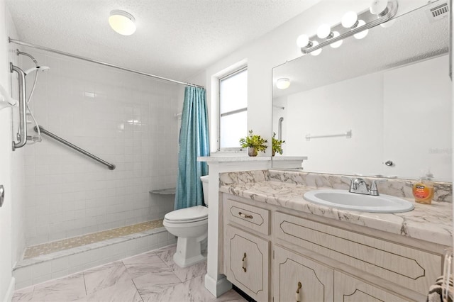 840 Virginia St Unit 301, Dunedin, FL 34698 - bathroom with tiled shower, vanity, a textured ceiling, and marble finish flooring