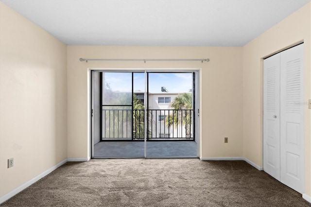 840 Virginia St Unit 301, Dunedin, FL 34698 - unfurnished bedroom with access to outside, carpet flooring, and a closet