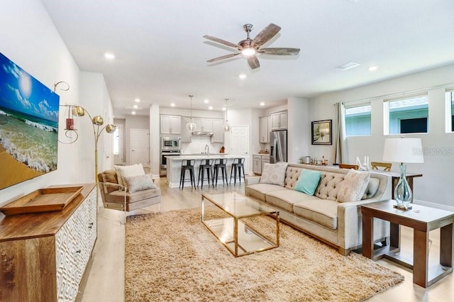11809 Catawba Cv, Parrish, FL 34219 - living area featuring light wood-style floors, ceiling fan, and recessed lighting