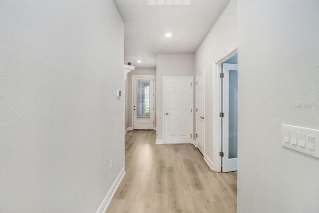 11809 Catawba Cv, Parrish, FL 34219 - corridor with light wood-style floors and baseboards