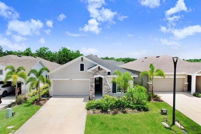 11809 Catawba Cv, Parrish, FL 34219 - view of front of property with stone siding, concrete driveway, and a garage