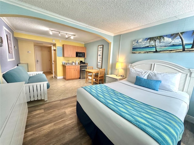 445 S Gulfview Blvd Unit 421, Clearwater Beach, FL 33767 - bedroom with a textured ceiling, crown molding, arched walkways, track lighting, and light wood-type flooring