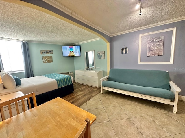 445 S Gulfview Blvd Unit 421, Clearwater Beach, FL 33767 - bedroom with a textured ceiling, ornamental molding, tile patterned flooring, and arched walkways