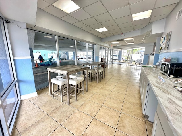 445 S Gulfview Blvd Unit 421, Clearwater Beach, FL 33767 - dining area with a paneled ceiling and light tile patterned flooring