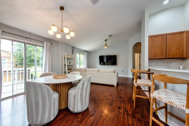 7001 Interbay Blvd Unit 121, Tampa, FL 33616 - dining area featuring vaulted ceiling, arched walkways, dark wood finished floors, plenty of natural light, and a chandelier