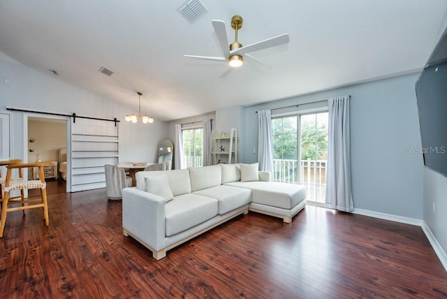 7001 Interbay Blvd Unit 121, Tampa, FL 33616 - living area with vaulted ceiling, a barn door, dark wood-style flooring, ceiling fan, and a chandelier