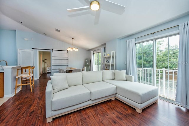 7001 Interbay Blvd Unit 121, Tampa, FL 33616 - living room with a barn door, lofted ceiling, dark wood-type flooring, and a ceiling fan