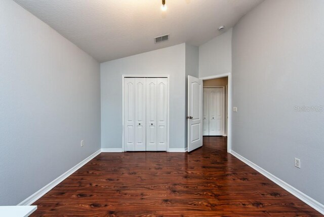 7001 Interbay Blvd Unit 121, Tampa, FL 33616 - unfurnished bedroom featuring lofted ceiling, wood finished floors, and a closet