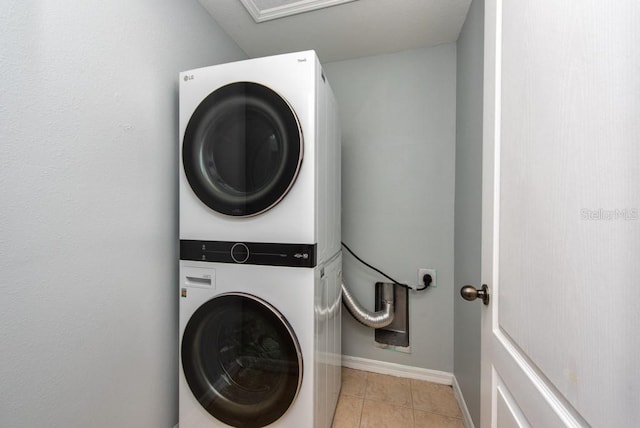 7001 Interbay Blvd Unit 121, Tampa, FL 33616 - laundry area featuring stacked washing machine and dryer and light tile patterned floors