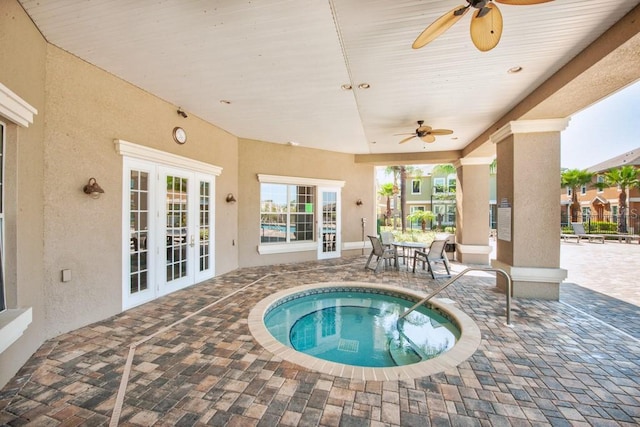7001 Interbay Blvd Unit 121, Tampa, FL 33616 - view of swimming pool featuring ceiling fan, a patio area, french doors, and a community hot tub
