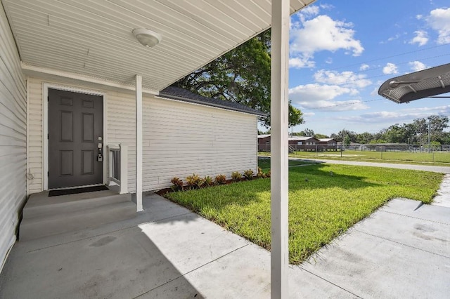 38323 11th Ave, Zephyrhills, FL 33542 - view of exterior entry with a lawn