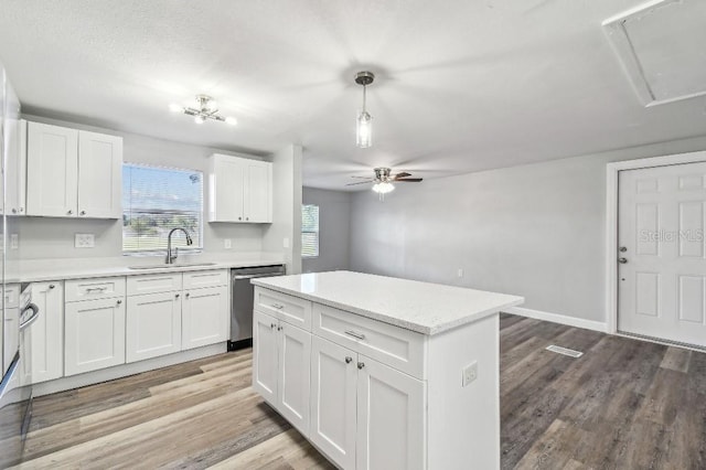 38323 11th Ave, Zephyrhills, FL 33542 - kitchen featuring stainless steel dishwasher, ceiling fan, white cabinetry, and light wood-style floors