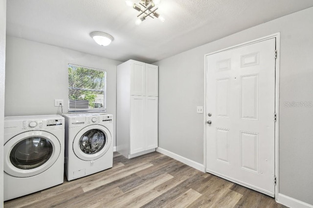 38323 11th Ave, Zephyrhills, FL 33542 - laundry area featuring separate washer and dryer, cabinet space, wood finished floors, and a textured ceiling