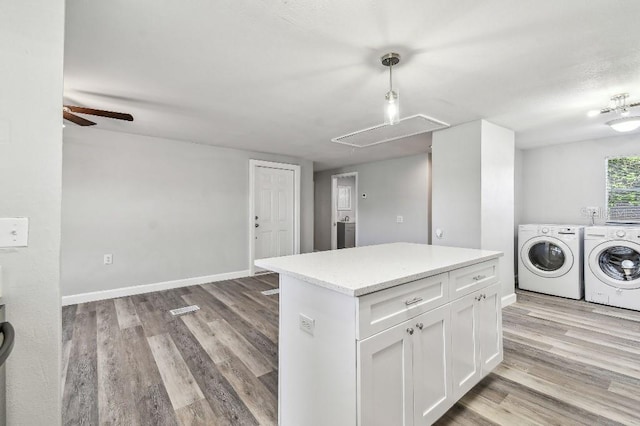 38323 11th Ave, Zephyrhills, FL 33542 - laundry room featuring attic access, independent washer and dryer, light wood finished floors, and a ceiling fan