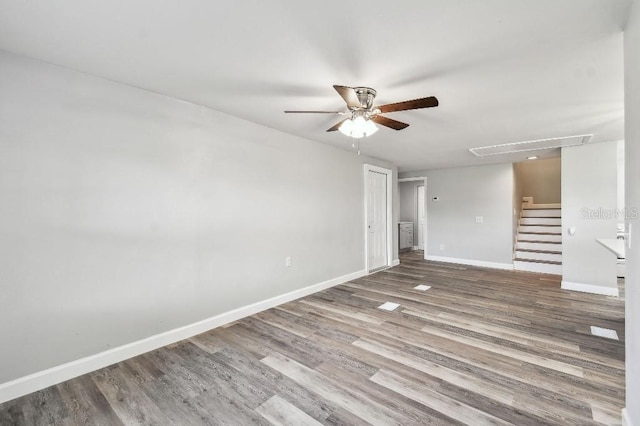 38323 11th Ave, Zephyrhills, FL 33542 - unfurnished room with ceiling fan, wood finished floors, and stairs