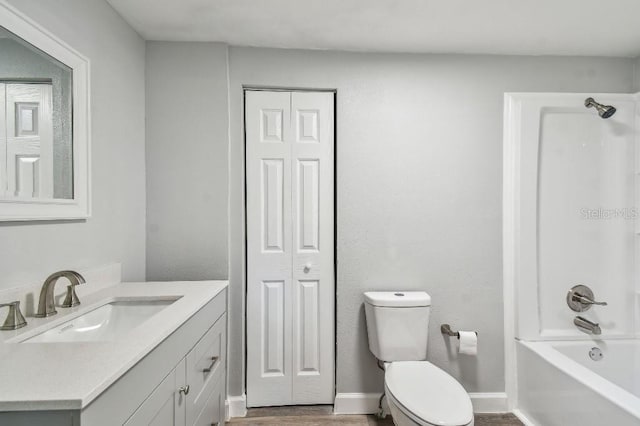 38323 11th Ave, Zephyrhills, FL 33542 - bathroom with vanity, a closet, tub / shower combination, and wood finished floors
