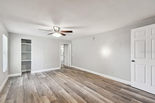 38323 11th Ave, Zephyrhills, FL 33542 - unfurnished bedroom with wood finished floors and a ceiling fan