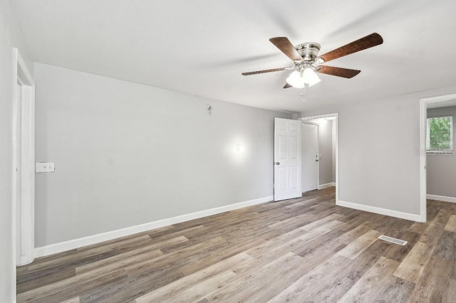 38323 11th Ave, Zephyrhills, FL 33542 - unfurnished bedroom featuring wood finished floors and a ceiling fan