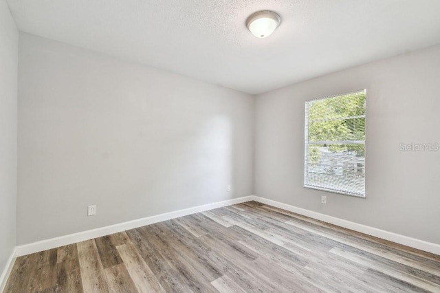 38323 11th Ave, Zephyrhills, FL 33542 - empty room featuring wood finished floors