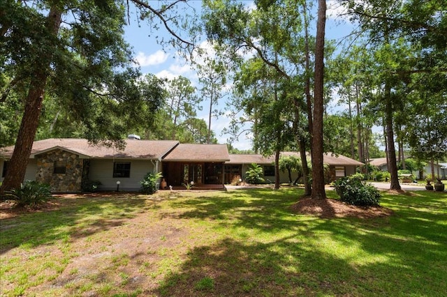 935 Ranch Rd, Tarpon Springs, FL 34688 - back of house with a yard and stone siding