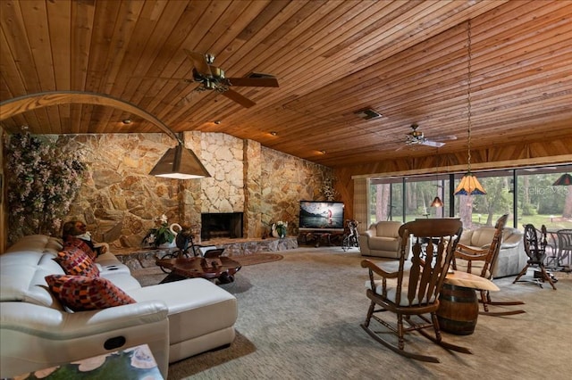 935 Ranch Rd, Tarpon Springs, FL 34688 - carpeted living room featuring wooden ceiling, ceiling fan, a stone fireplace, and vaulted ceiling