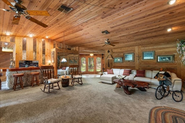 935 Ranch Rd, Tarpon Springs, FL 34688 - carpeted living room with ceiling fan, wood ceiling, and wooden walls