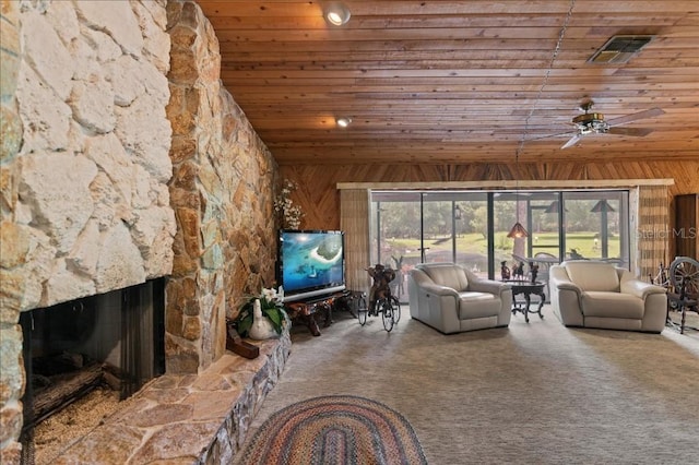 935 Ranch Rd, Tarpon Springs, FL 34688 - living room featuring wooden ceiling, wood walls, a fireplace, carpet floors, and vaulted ceiling