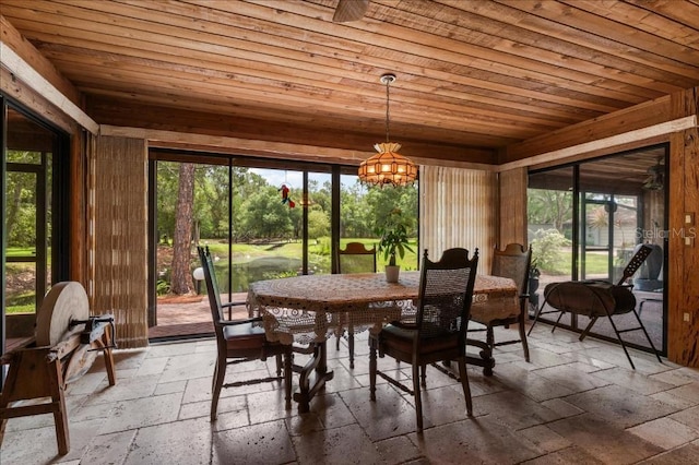 935 Ranch Rd, Tarpon Springs, FL 34688 - sunroom featuring a chandelier, plenty of natural light, and outdoor dining space