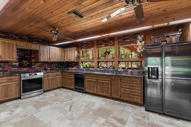 935 Ranch Rd, Tarpon Springs, FL 34688 - kitchen with appliances with stainless steel finishes, ceiling fan, stone tile floors, dark countertops, and wood ceiling
