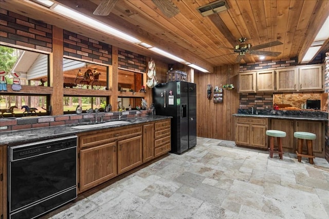 935 Ranch Rd, Tarpon Springs, FL 34688 - kitchen with black appliances, stone tile floors, wooden ceiling, brown cabinetry, and dark countertops