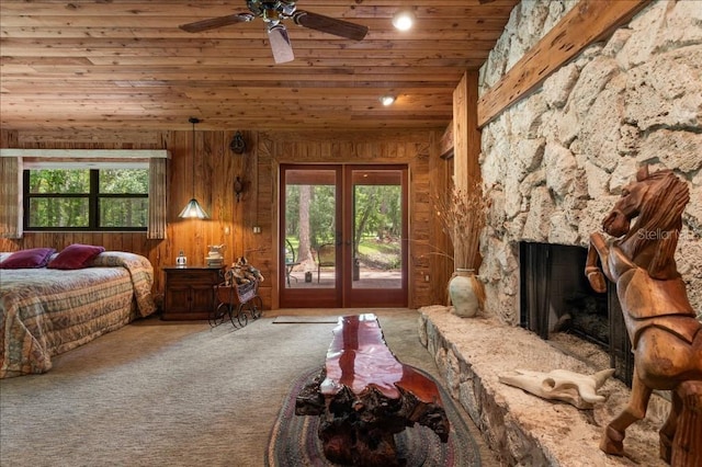 935 Ranch Rd, Tarpon Springs, FL 34688 - bedroom featuring wooden ceiling, access to outside, multiple windows, a stone fireplace, and wooden walls