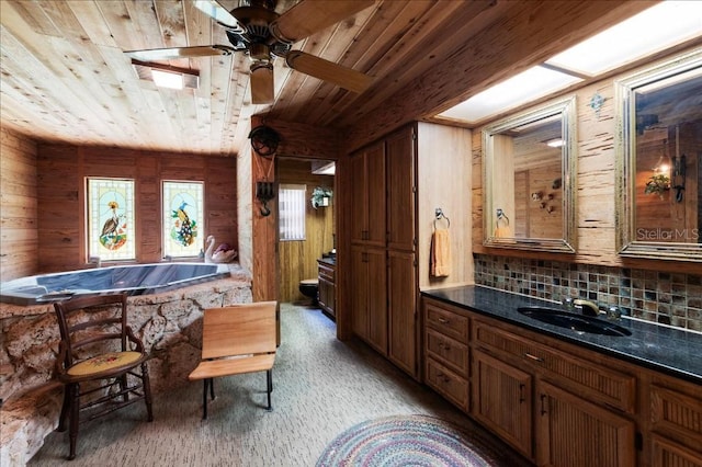 935 Ranch Rd, Tarpon Springs, FL 34688 - full bath featuring wooden ceiling, wooden walls, ceiling fan, decorative backsplash, and vanity