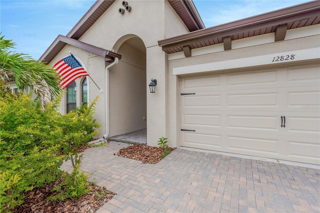 12828 Satin Lily Dr, Riverview, FL 33579 - entrance to property featuring stucco siding and decorative driveway