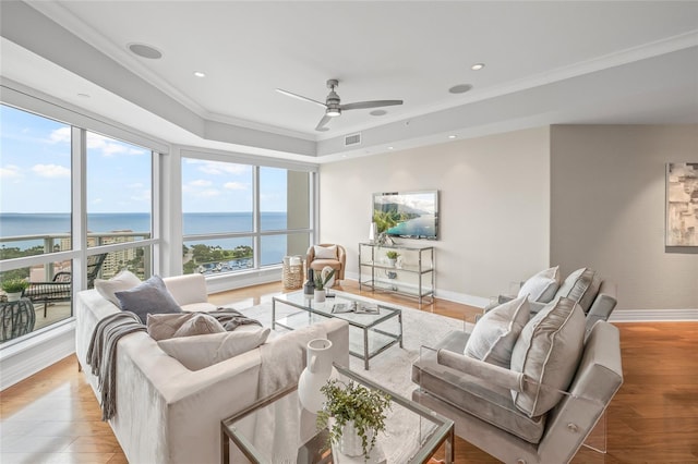 400 Beach Dr NE Unit 2301, Saint Petersburg, FL 33701 - living room with a ceiling fan, a tray ceiling, crown molding, a water view, and light wood finished floors