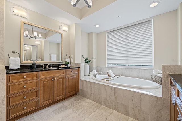400 Beach Dr NE Unit 2301, Saint Petersburg, FL 33701 - bathroom featuring vanity, a garden tub, marble look tiles, and a chandelier