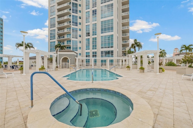400 Beach Dr NE Unit 2301, Saint Petersburg, FL 33701 - community pool with a pergola, a community hot tub, and a patio