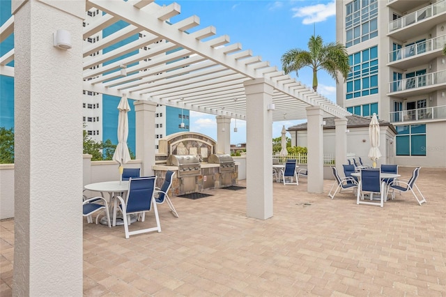 400 Beach Dr NE Unit 2301, Saint Petersburg, FL 33701 - view of patio with outdoor dining area, an outdoor kitchen, and a pergola