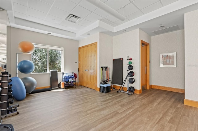 400 Beach Dr NE Unit 2301, Saint Petersburg, FL 33701 - workout area featuring light wood-style floors, a tray ceiling, and a paneled ceiling