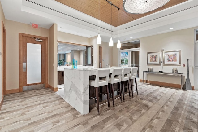 400 Beach Dr NE Unit 2301, Saint Petersburg, FL 33701 - kitchen with light carpet, decorative light fixtures, a breakfast bar, recessed lighting, and a raised ceiling