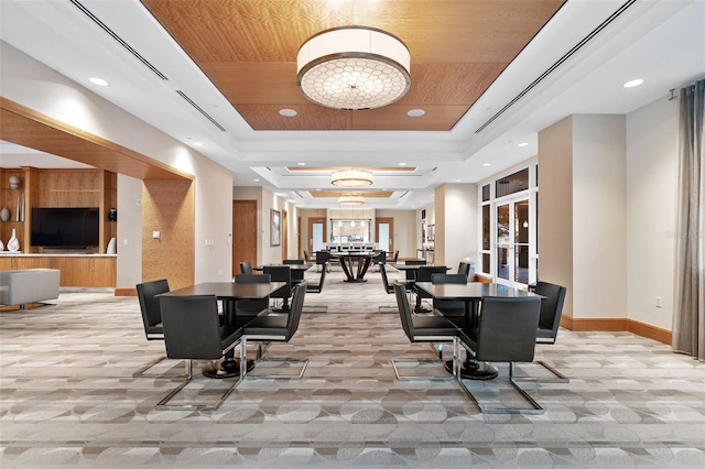 400 Beach Dr NE Unit 2301, Saint Petersburg, FL 33701 - dining space with a tray ceiling, light colored carpet, recessed lighting, and a chandelier
