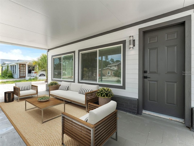 960 65th St S, Saint Petersburg, FL 33707 - covered porch featuring an outdoor living space
