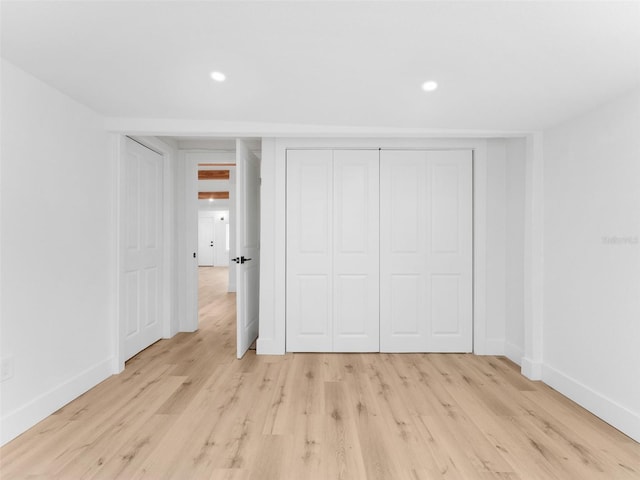960 65th St S, Saint Petersburg, FL 33707 - unfurnished bedroom featuring light wood finished floors, recessed lighting, and a closet