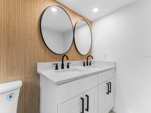 960 65th St S, Saint Petersburg, FL 33707 - bathroom with double vanity, wood walls, and recessed lighting