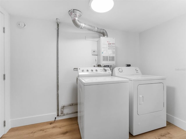 960 65th St S, Saint Petersburg, FL 33707 - washroom with washer and clothes dryer and light wood-style flooring