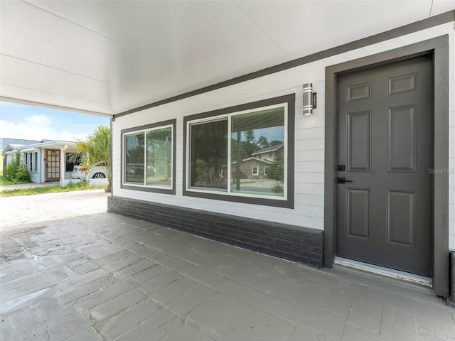 960 65th St S, Saint Petersburg, FL 33707 - doorway to property featuring a porch