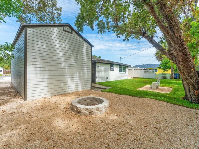 960 65th St S, Saint Petersburg, FL 33707 - back of property featuring an outdoor fire pit