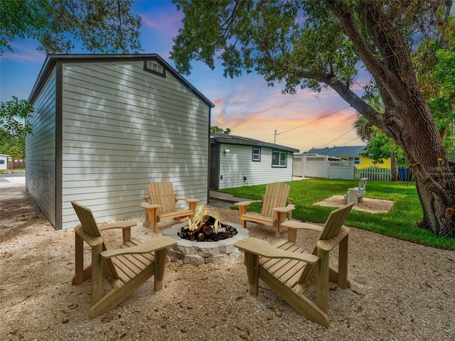 960 65th St S, Saint Petersburg, FL 33707 - back of property at dusk featuring a fire pit