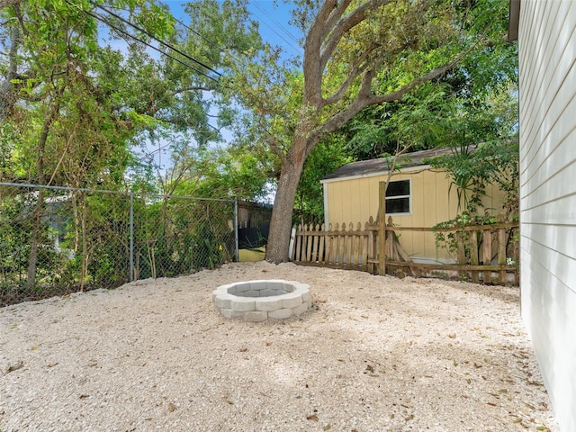 960 65th St S, Saint Petersburg, FL 33707 - fenced backyard with a fire pit and a shed