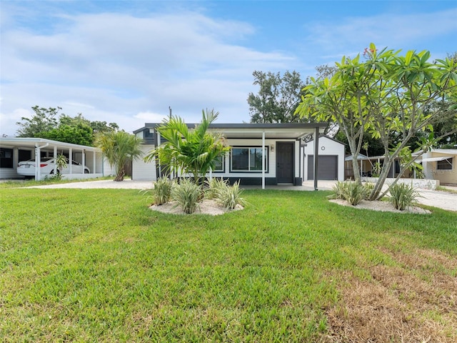 960 65th St S, Saint Petersburg, FL 33707 - view of front of house featuring a front lawn, driveway, and an attached garage
