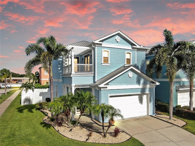 6545 Simone Shores Cir, Apollo Beach, FL 33572 - view of front of house with a balcony, a front lawn, concrete driveway, and an attached garage